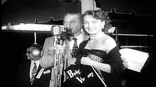 Peggy Dow and Arthur Kennedy sign autographs for people at the premiere of movie HD Stock Footage